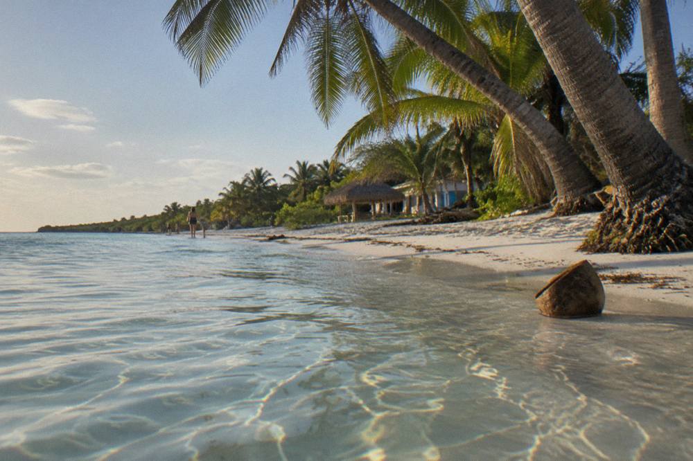 Shallow turquoise water and white sand at a quiet public beach on Isla Mujeres
