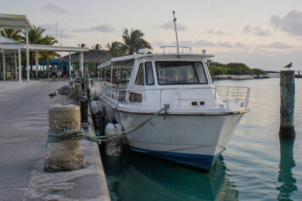 Ferry terminal at a calm Caribbean marina with a passenger boat at the dock
