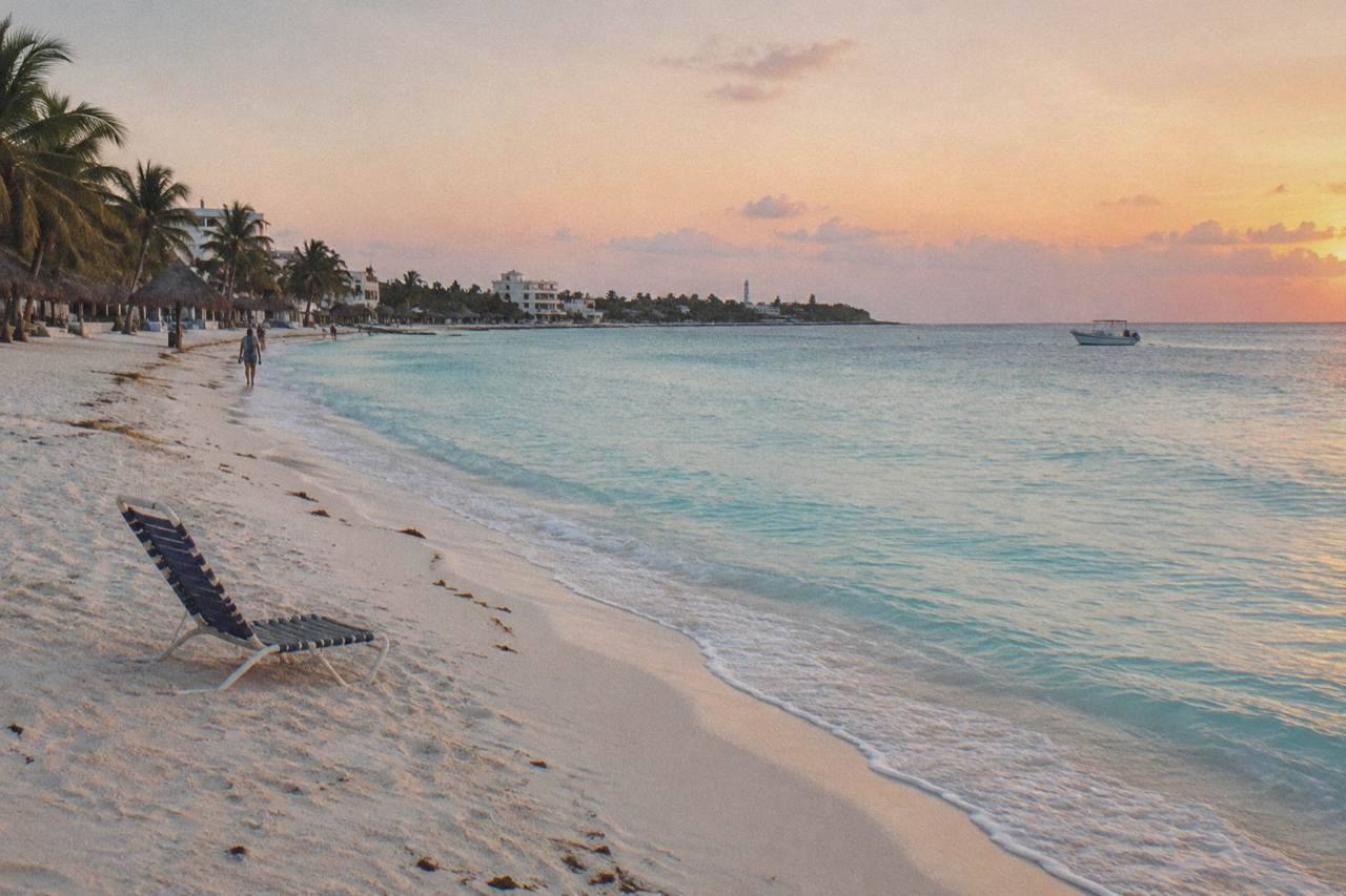 Wide sandy beach with calm turquoise water along a northern shoreline of a small island