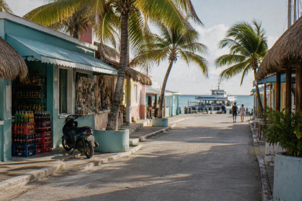 Colorful small town street with shops and palm trees on a Caribbean island
