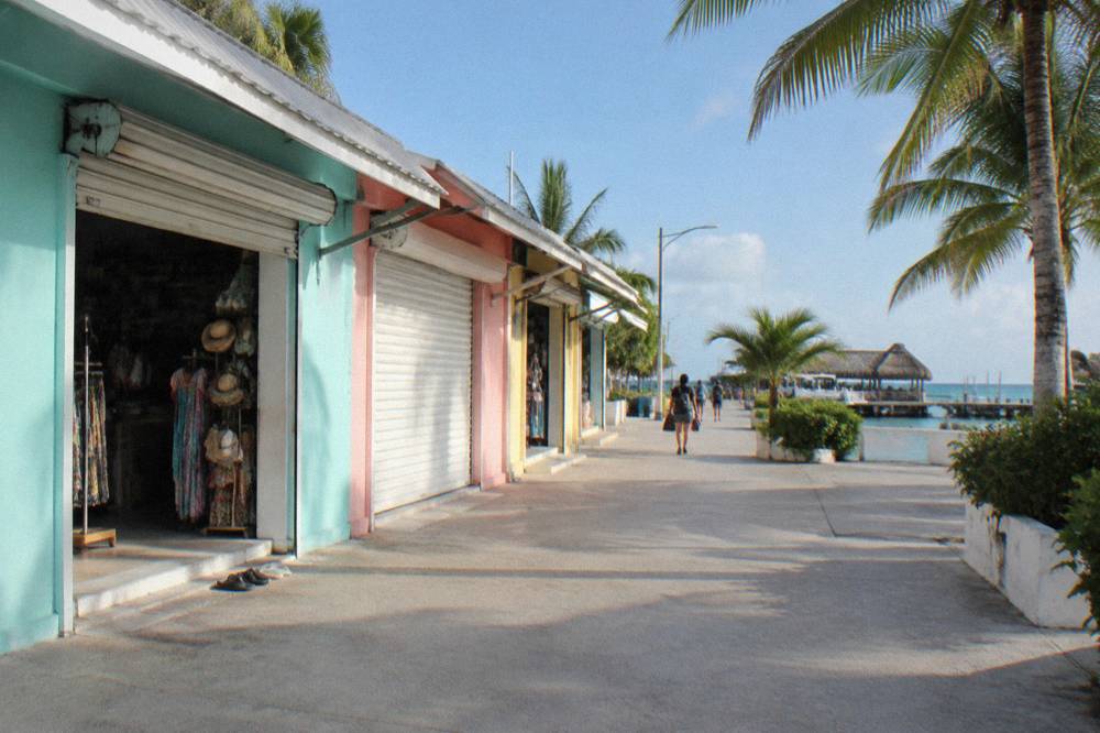 Colorful downtown street on Isla Mujeres with shops opening in morning light