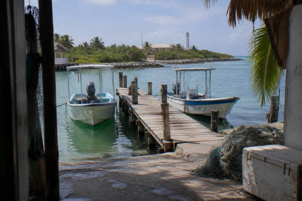 Small wooden dock in an island town with moored fishing boats
