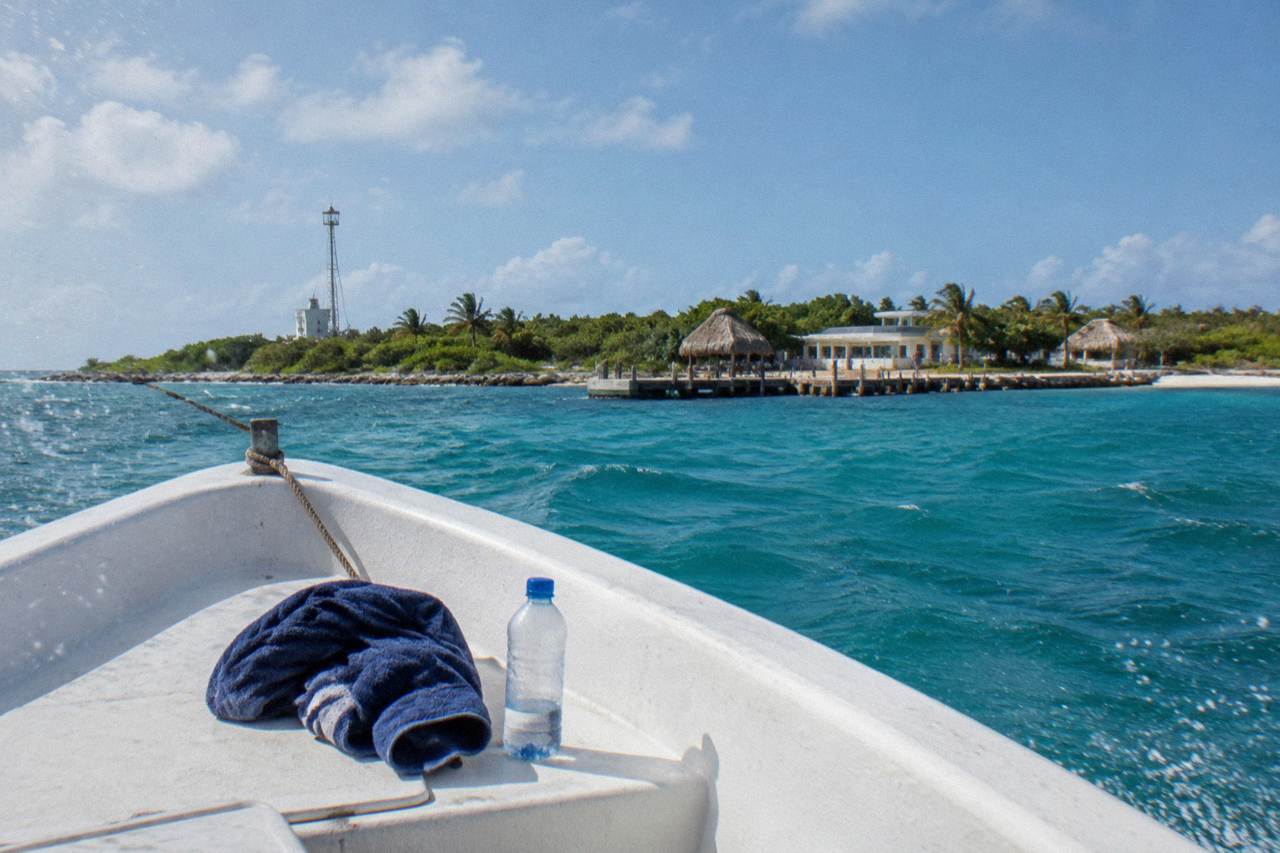 Open Caribbean water north of Isla Mujeres with a low island on the horizon